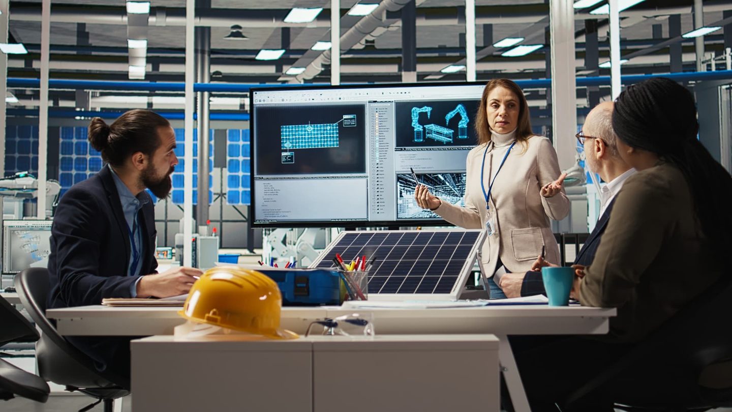 Engineering team reviewing solar cell performance data together